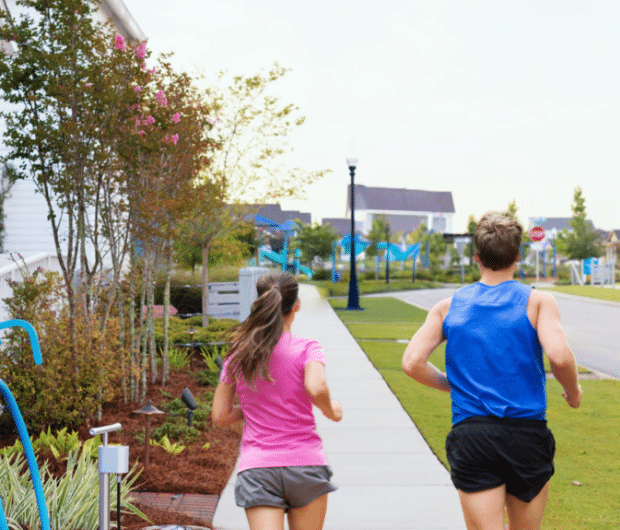 fit man and woman running in the Inaugural Run UA Presented by SweetBay